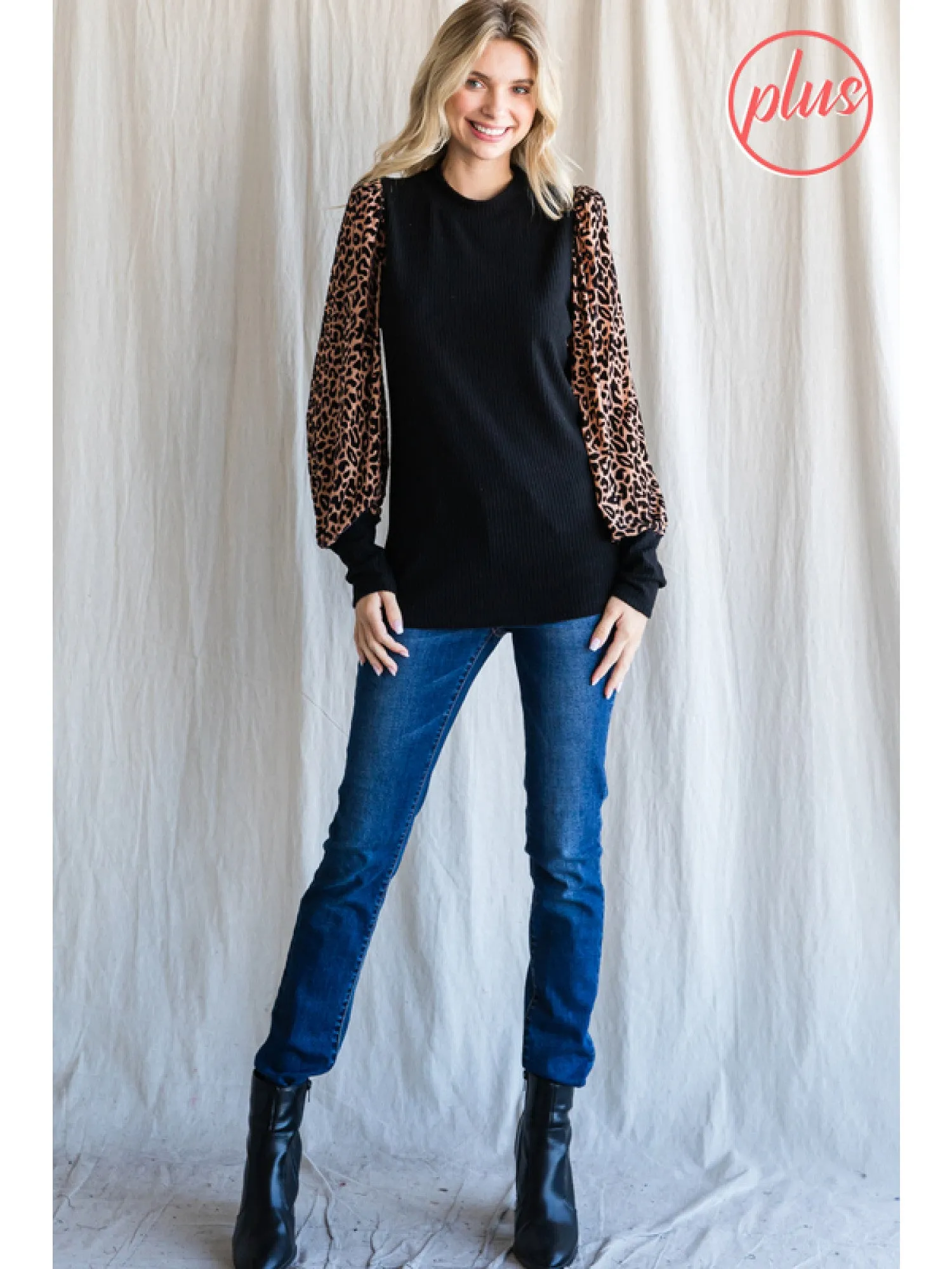 Solid knit top with leopard print sleeves